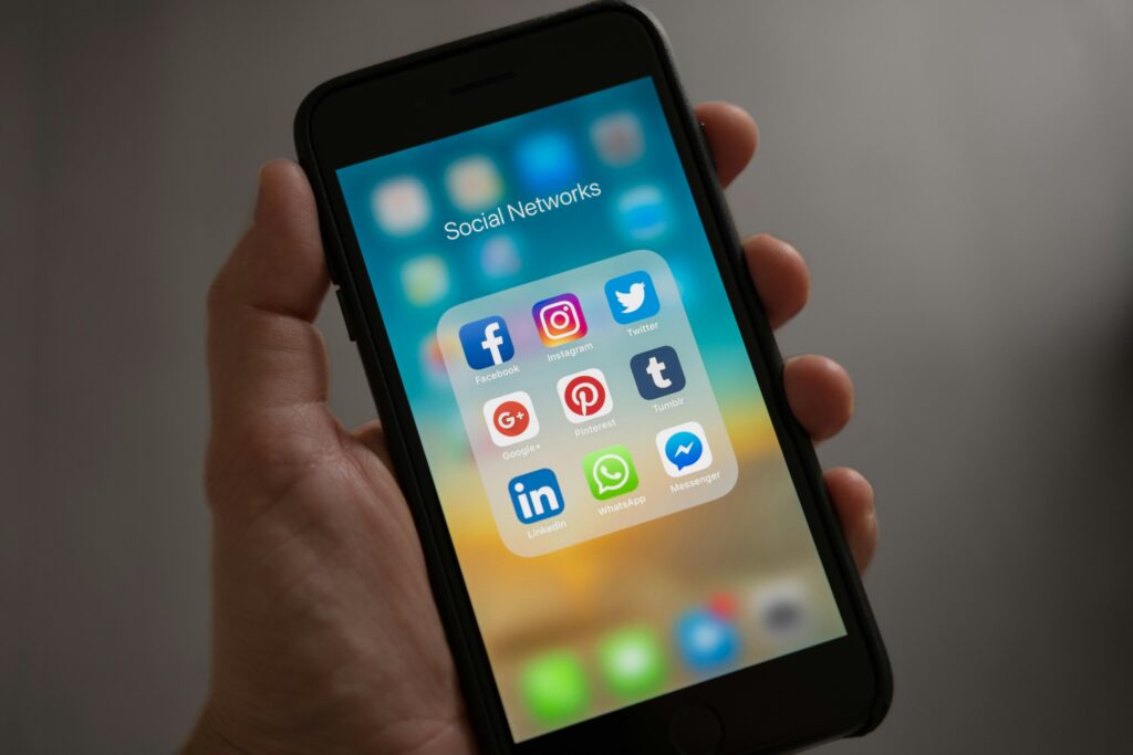 pexels-photo-607812-607812-2 A smartphone displaying various social media icons held in a hand, showcasing modern communication apps.